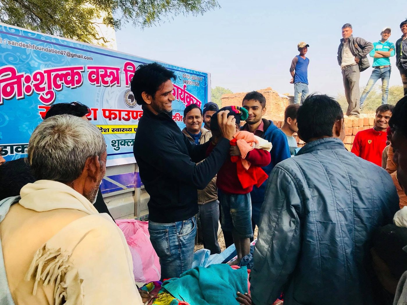 Volunteers distributing clothes at a free cloth distribution drive